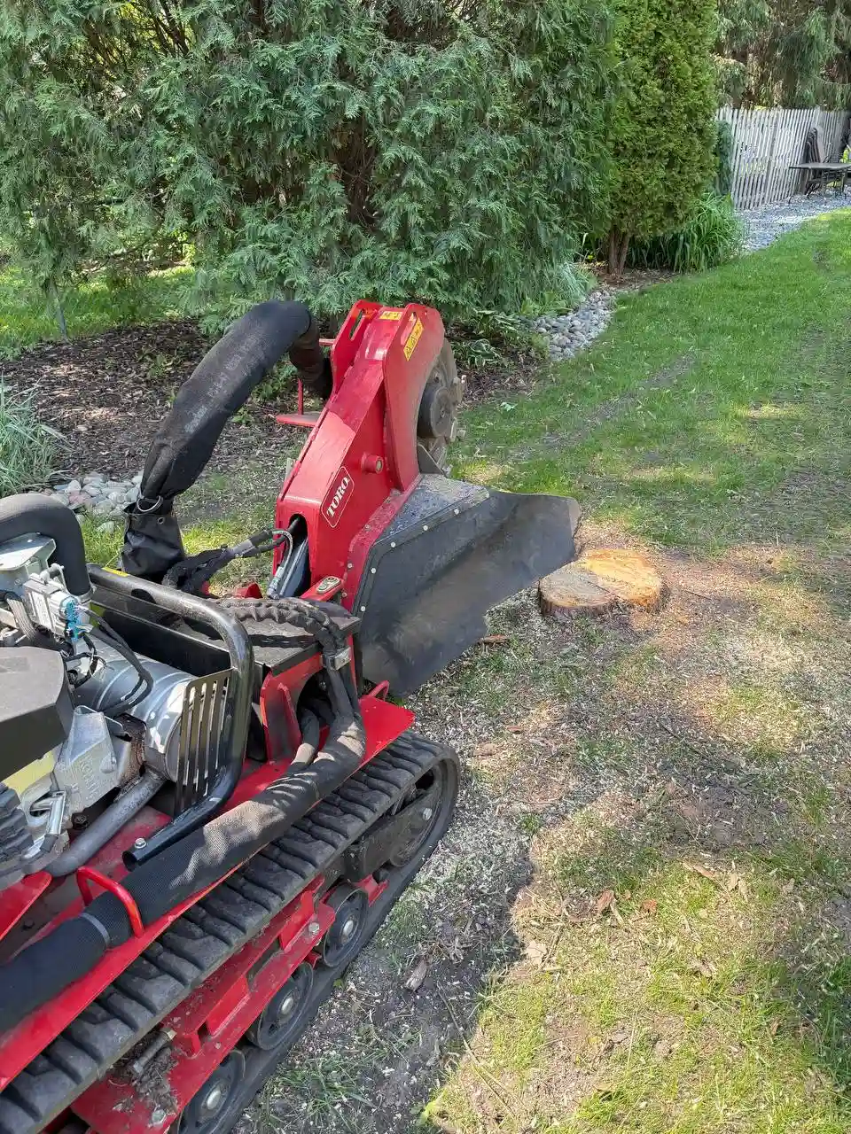 Stump grinding near house foundation in Minnetonka MN